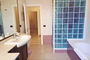 A bathroom with a sink, mirror, and a glass shower enclosure. - In the Como Borghi Area (Ganymede Apartment) (Como)