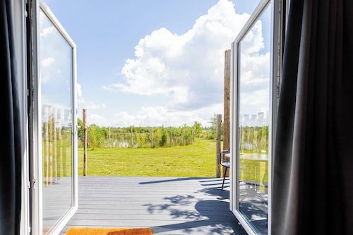 Knus tiny house met verwarmd buitenbad aan de vijver. Geniet van privacy, fluisterende natuur en adembenemende uitzichten bij 't Nije Hemelriek.