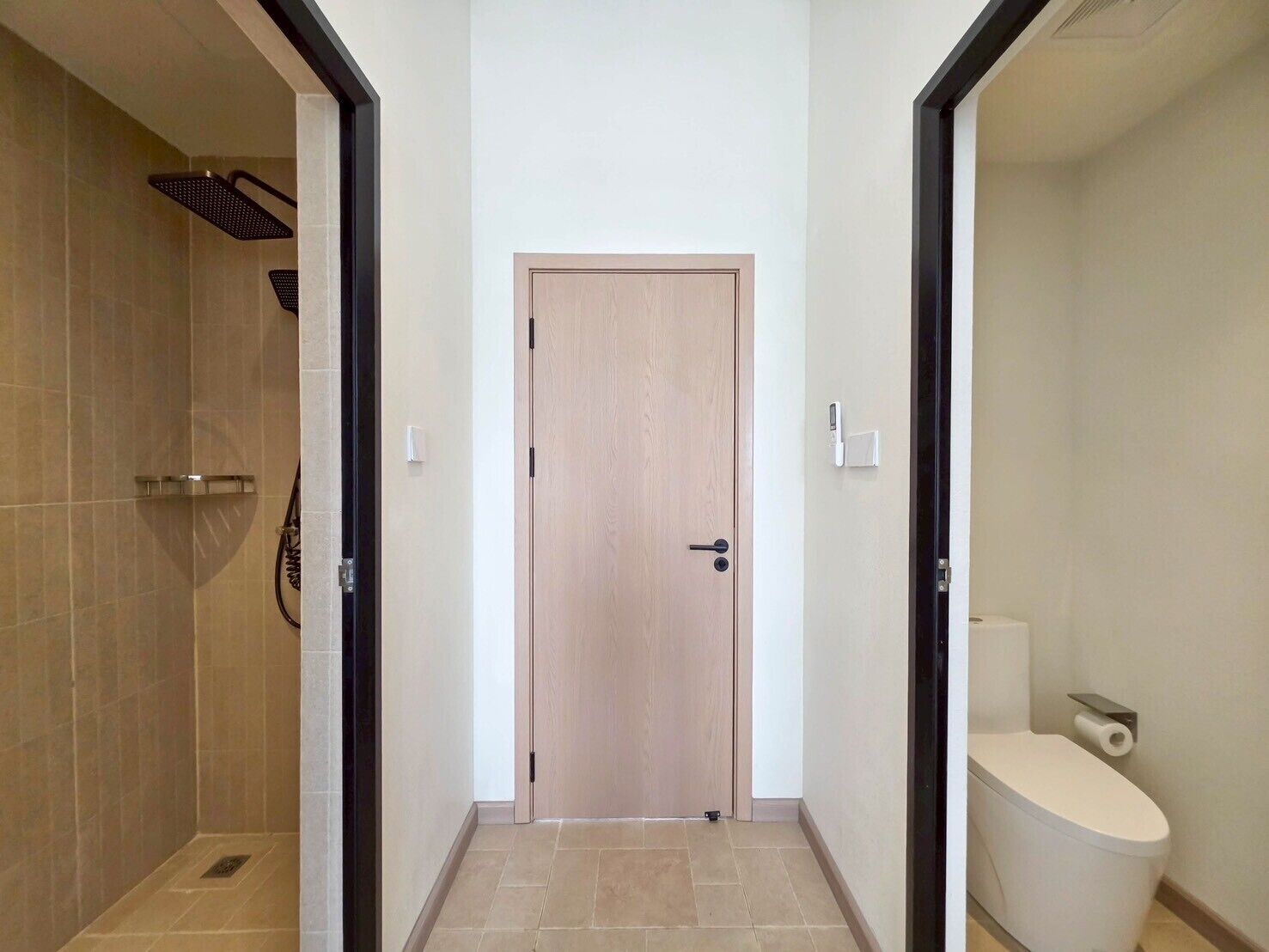 A bathroom with a toilet, a shower, and a door.