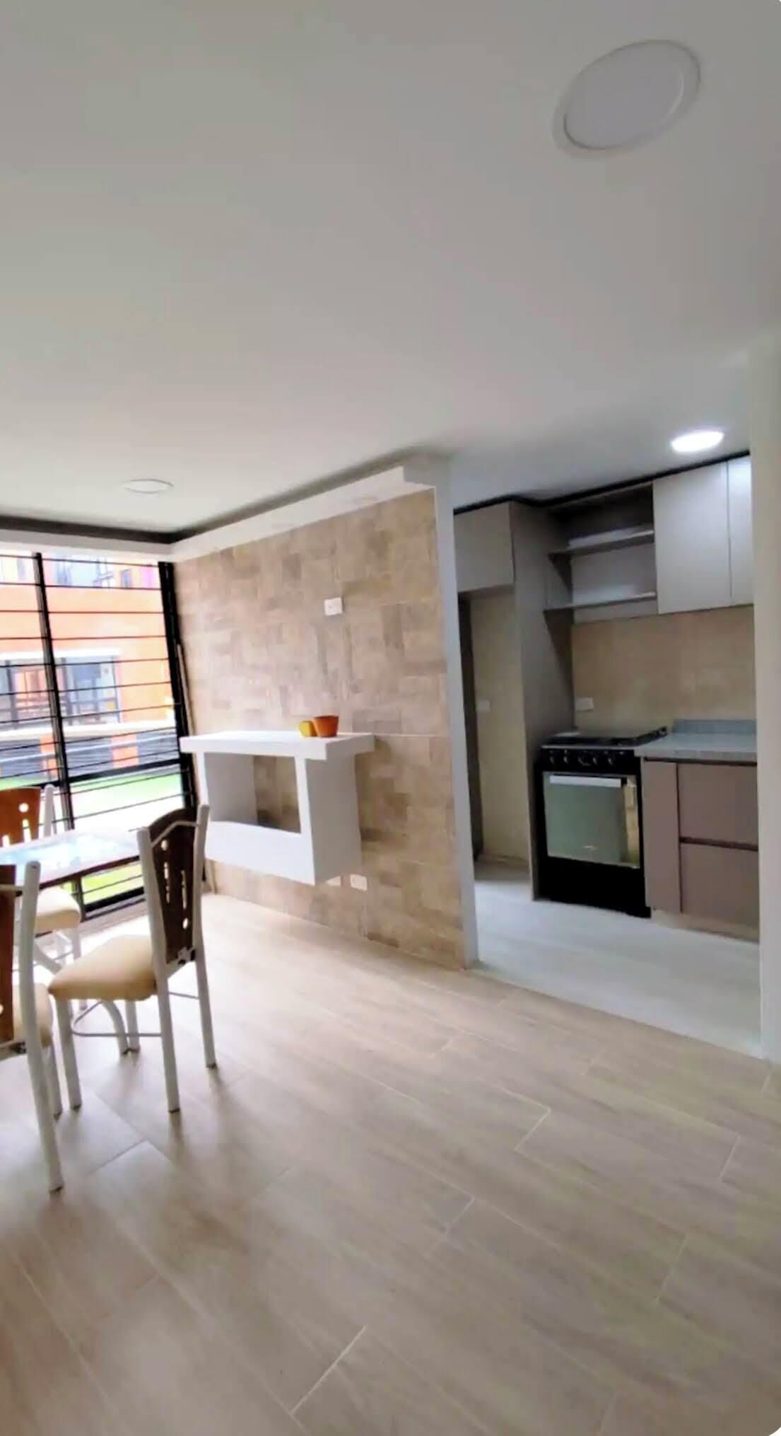 A modern kitchen with a stove, oven, and white cabinets.
