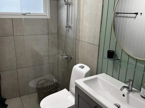 A bathroom with a shower, toilet, and sink. - 4 Star Holiday Home in Hovborg (Hovborg)