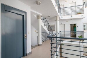 A multi-level interior with a staircase, columns, and a balcony. - Central Polynesia Apartment in Ronda (Ronda)