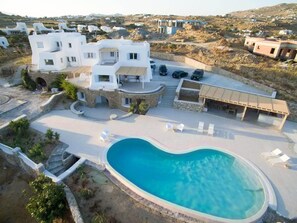 A modern villa with a swimming pool, multiple bedrooms, and a covered outdoor area. - The Mykonian Escape (Mykonos)