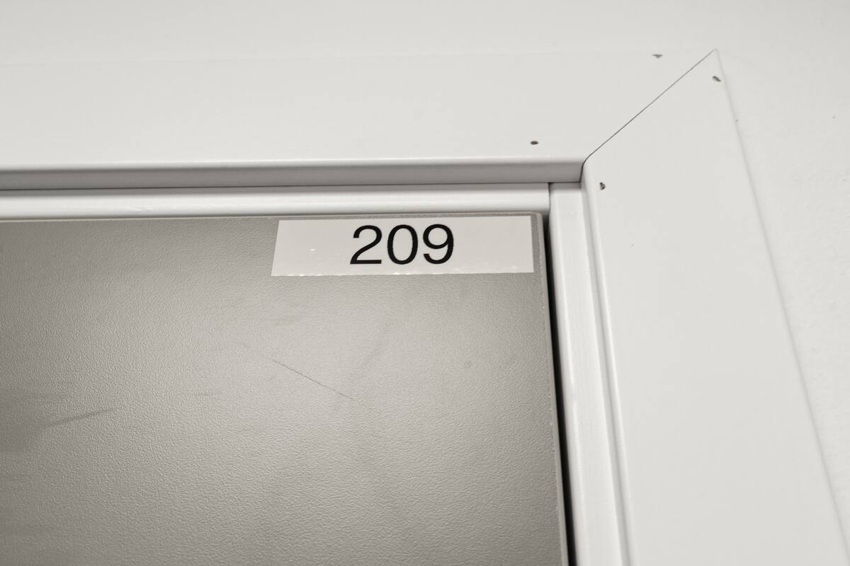 A white door with a number '209' on it.