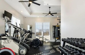 A gym with treadmills, dumbbells, and a punching bag. - Modern 2br Townhome in Prime Location (Clarksville)