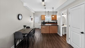 Une cuisine moderne avec des meubles en bois, un îlot central et des luminaires suspendus.