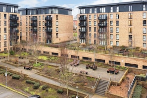 A multi-story residential building with balconies, a courtyard with seating, and a brick facade. - The Lincoln Tribe | 3 Bed Group Getaway | Parking (West Midlands)