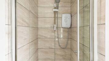 Shower, hair dryer, towels, shampoo