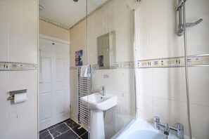 A bathroom with a glass shower enclosure, a white sink, and a bathtub. - H17A Cosy & Welcoming home (West Yorkshire)