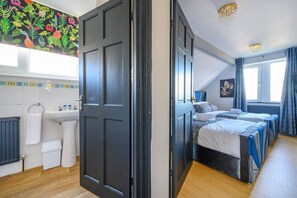 A room with a bed, a window with curtains, a radiator, and a sink. - 14GH* For your relaxed and Cosy stay with Free (West Yorkshire)