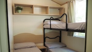 A bunk bed room with a single bed on the bottom bunk and a shelf above. - 5-person Mobile Home Near Chianti (Bucine)