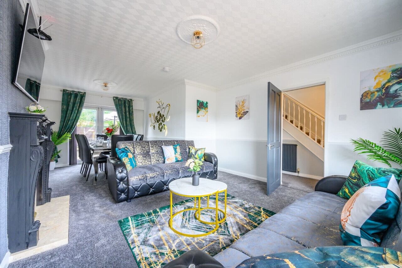 A living room with a sofa, a coffee table, a fireplace, and a staircase leading to another level.. *328OL* For your relaxed & Cosy stay + Parking