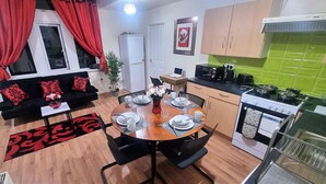 A compact living space with a dining area, kitchenette, and a sofa with red cushions. - *G11H* for a cosy luxurious lovely stay + Free Parking + Free Fast WiFi perfect for work or pleasure (West Yorkshire)