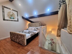 A bedroom with a bed, a nightstand, a radiator, and a wall-mounted picture. - *G11H* for a cosy luxurious lovely stay + Free Parking + Free Fast WiFi perfect for work or pleasure (West Yorkshire)