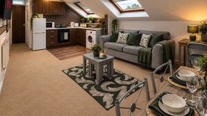 A compact living space with a kitchenette, dining area, and a sofa with a view of the sky through skylights. - *F15GH* Setup for your most relaxed & amazing stay + Free Parking + Free Fast WiFi (West Yorkshire)