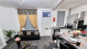 A compact living space with a sofa, dining table, and kitchen area. - *11BR* Setup for your most amazing relaxed stay + Free Parking + Free Fast WiFi (West Yorkshire)
