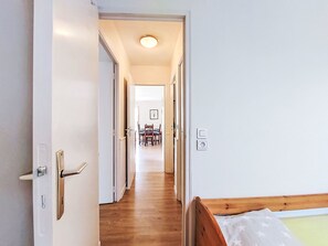 A hallway leading to a dining area with a table and chairs. - Claudel by Interhome (Saint Malo)