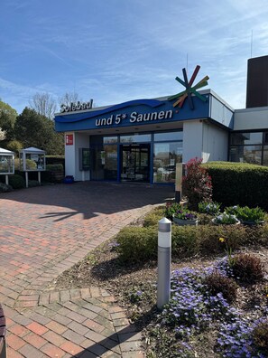 A building with a sign reading 'und 5* Saunen' and a modern design with a blue and white color scheme.