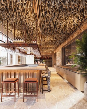 A bar area with stools, a counter, and a unique ceiling design. - Hotel Camelot By Artur (Ksamil)