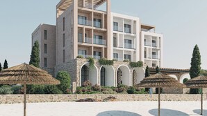 Un immeuble moderne à plusieurs étages, doté de balcons, d’une façade en pierre et de fenêtres en arc de cercle.