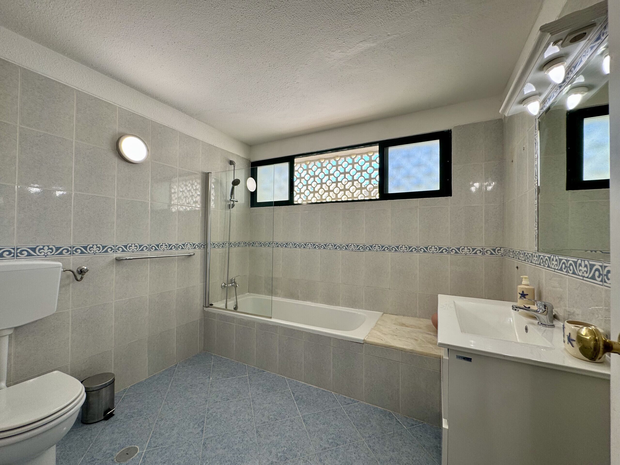 A bathroom with a toilet, a shower, a bathtub, and a sink.