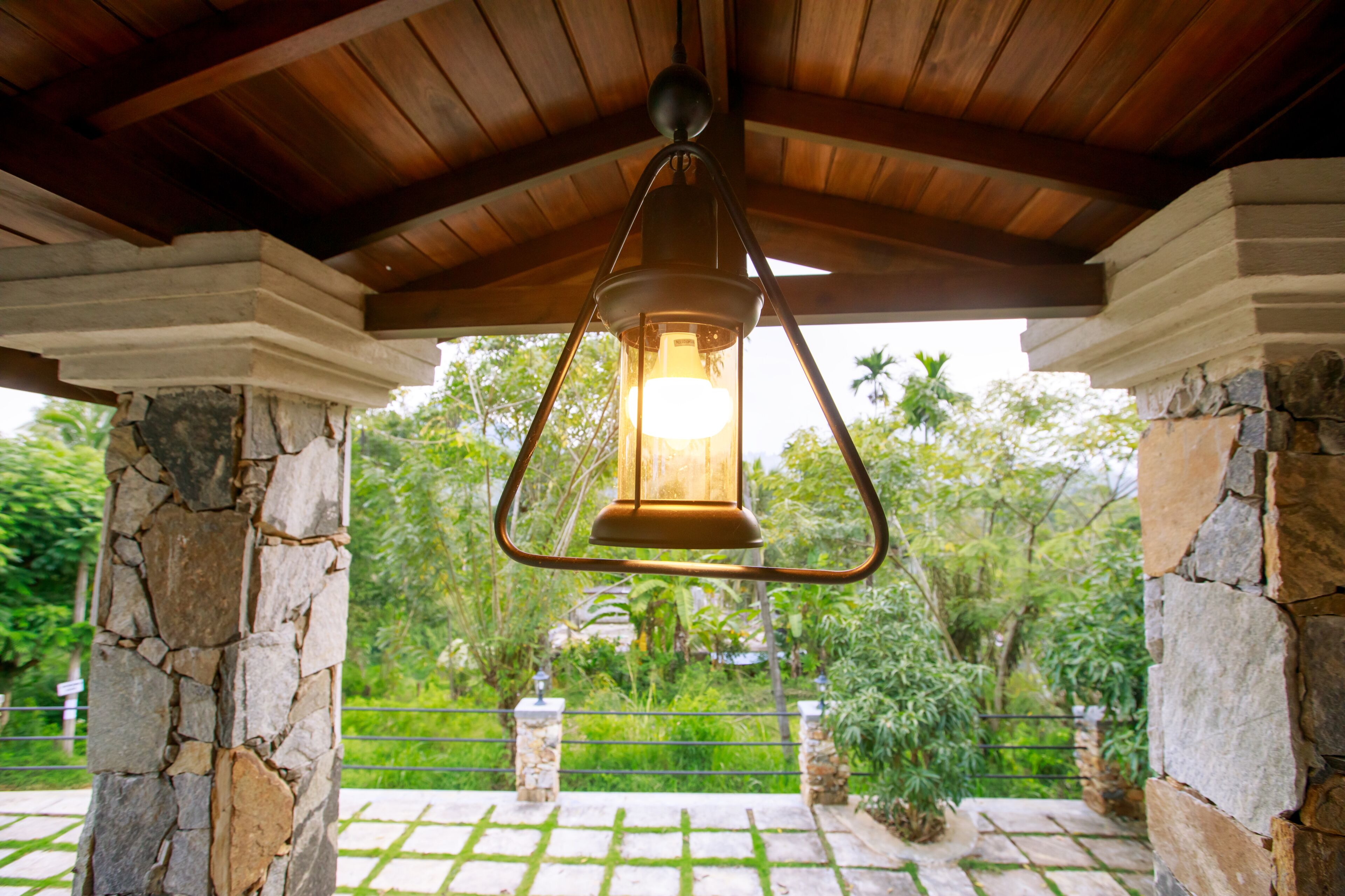 A stone pillar structure with a hanging lantern.