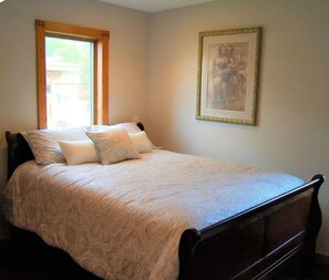A bedroom with a bed, a window, and a framed picture on the wall. - Lake St. Helen Retreat with Pontoon, Kayaks, Hot Tub & Easy ORV Trail Access (St. Helen)