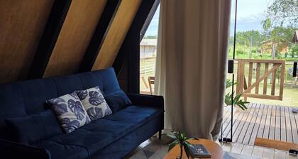 A retreat at Chalé A-Frame Parobé, with a lake, fire pit, and grill.