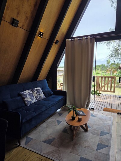 A retreat at Chalé A-Frame Parobé, with a lake, fire pit, and grill.