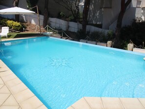 A rectangular swimming pool with a clear blue water surface, surrounded by a tiled deck. - House with sea view, pets allowed - 8 guests (Llançà)