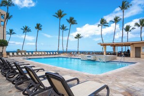 A poolside area with lounge chairs and a view of the ocean. - Sugar Beach Resort 232, Oceanfront Ocean View, Central A/C (Kihei)