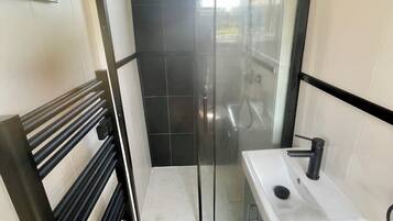 Shower, towels, soap, toilet paper