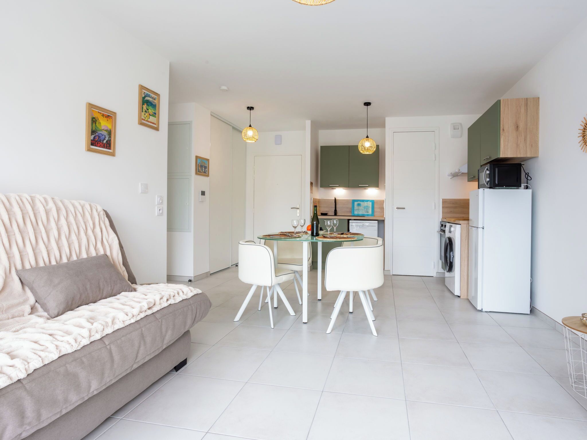 A modern apartment with a living area, a dining table, and a kitchen.