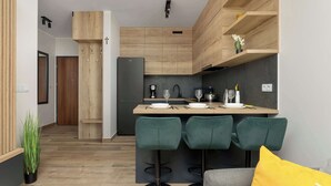 A modern kitchen with wooden cabinetry, a central island with bar stools, and a refrigerator. - Modern Apartment with Parking | Balcony | Smart TV (Sosnowiec)