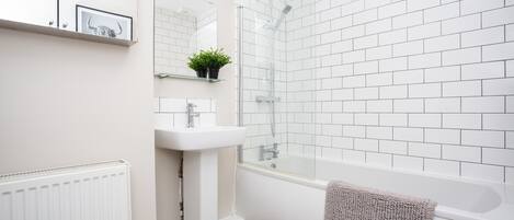 Shower, hair dryer, towels, shampoo