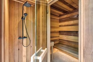A wooden sauna with a glass door, a showerhead, and a bench. - Fawns Keep - Hot Tub & Sauna Retreat | Ridgestone (Bowness-on-Windermere)