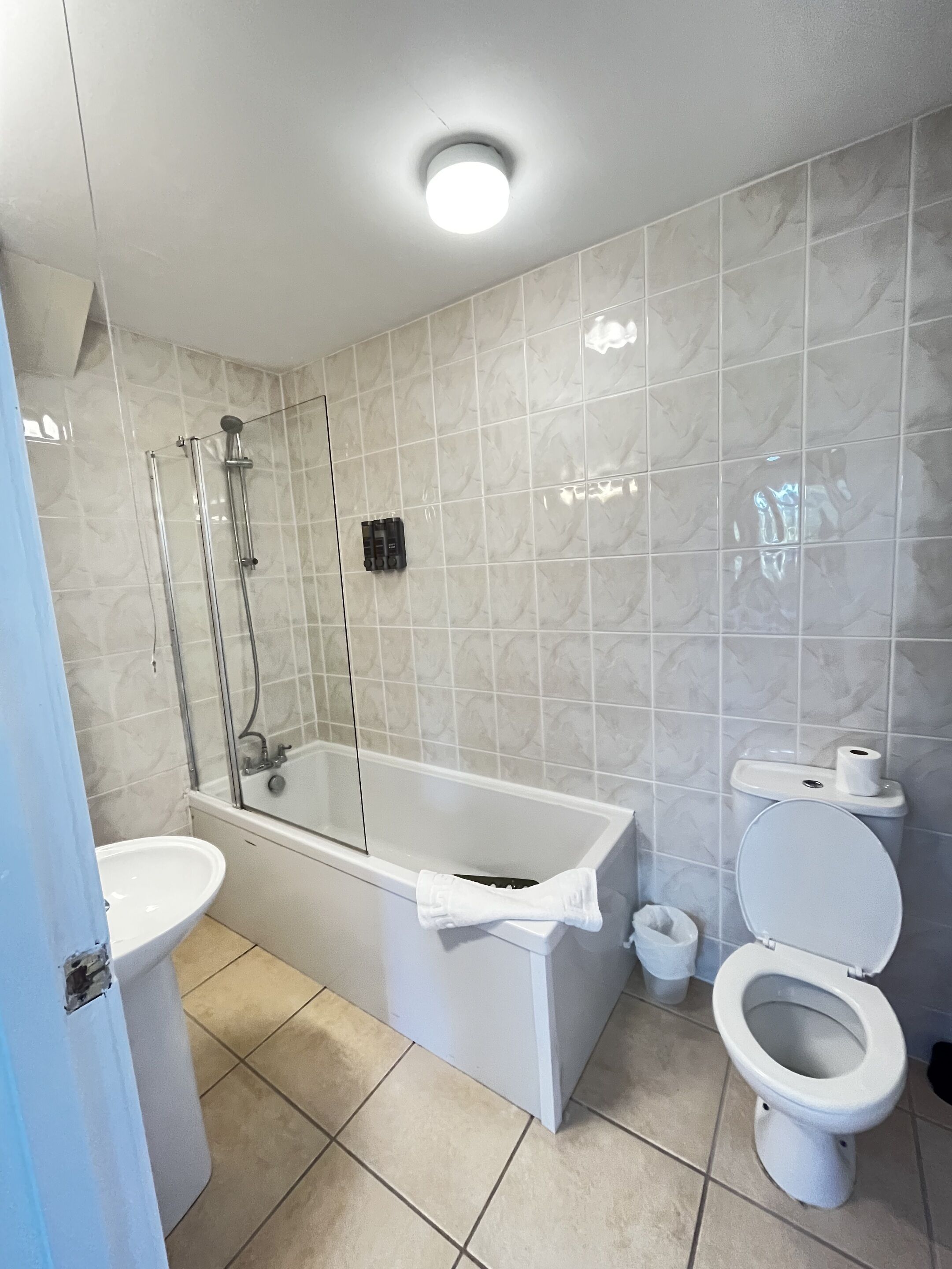 A bathroom with a bathtub, toilet, and sink, all in white.