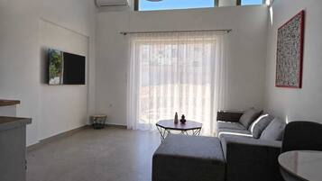 Deluxe appartement, uitzicht op tuin | Woonruimte