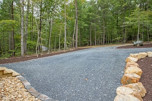 A gravel driveway with a stone border, surrounded by a forest. - Shenandoah, Firepit, peaceful Cabin w/salt water Hot tub! (Luray)