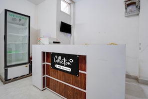 A reception desk with a sign reading 'Collection' and 'Oyo-Serviced'.
