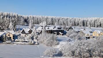 Ett snötäckt bostadsområde med hus och en klar himmel.
