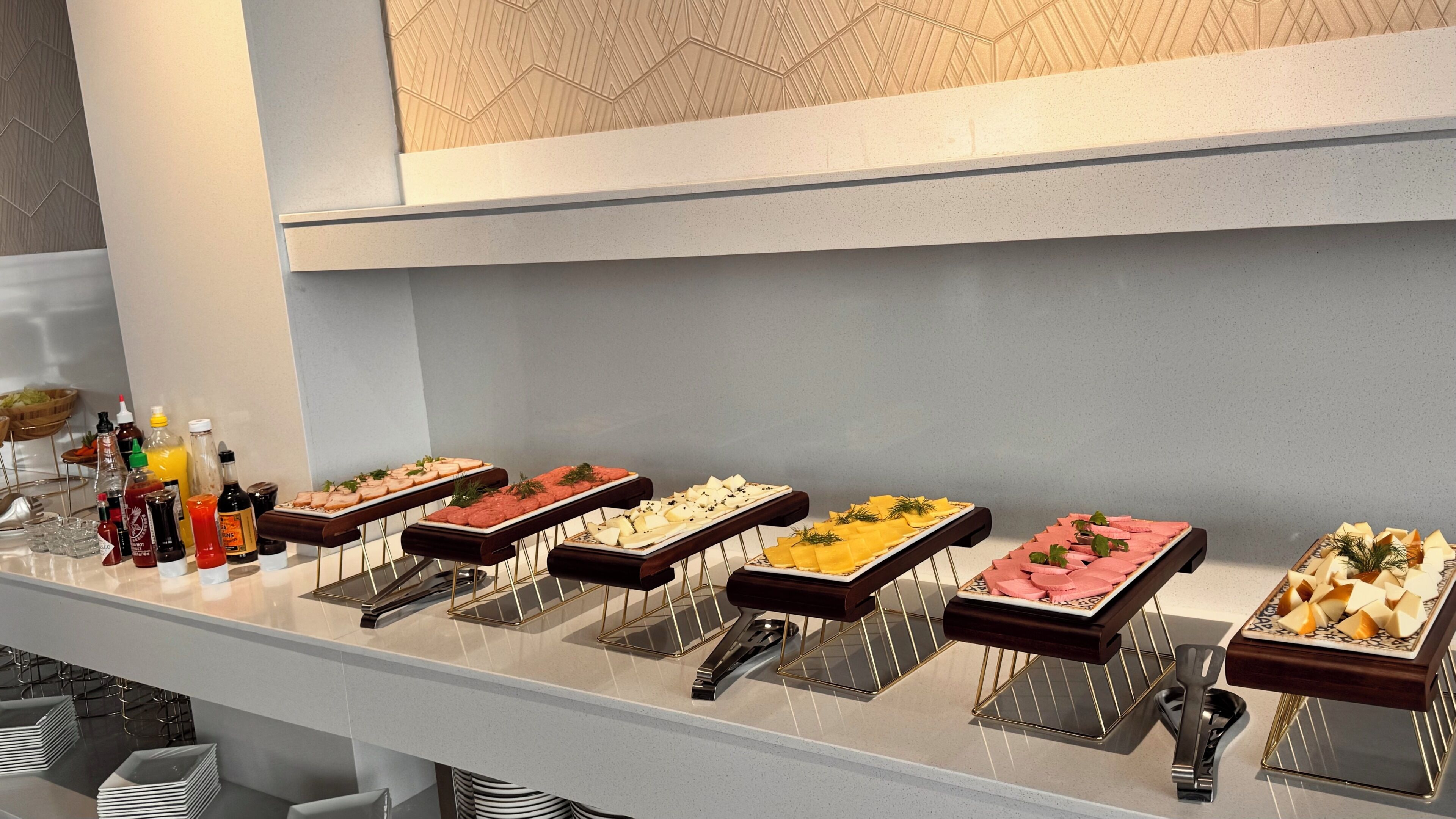 A buffet with various food items and condiments.