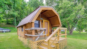 A log cabin with a porch and a staircase leading to the entrance. - Lakefront Home and 2 Cabins on Claytor Lake (Hiwassee)