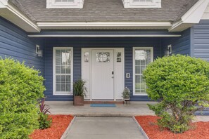 A house with a front porch, a white door, and two windows. - Peaceful Lake Escape w/ Dock in Coffee County (Douglas)