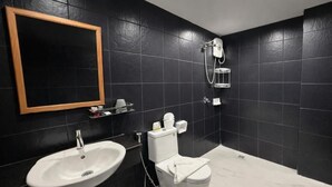 A bathroom with a white sink, toilet, and shower. - Central Perk Patong (Patong)