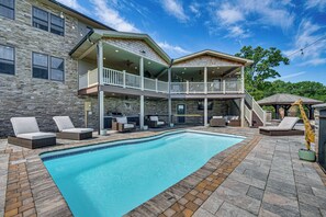 A swimming pool with lounge chairs, a covered patio, and a stone exterior. - Pool, Hot Tub + Views: Spacious Danville Escape! (Danville)