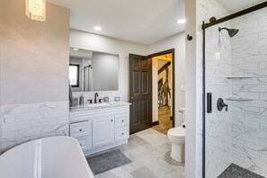 A bathroom with a bathtub, a vanity with a mirror, a toilet, and a shower with a glass door. - Pool, Hot Tub + Views: Spacious Danville Escape! (Danville)