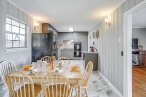 A dining area with a wooden table and chairs, a kitchen in the background, and a view of the living room. - Minutes From Chattanooga / The Scenic City (Rossville)