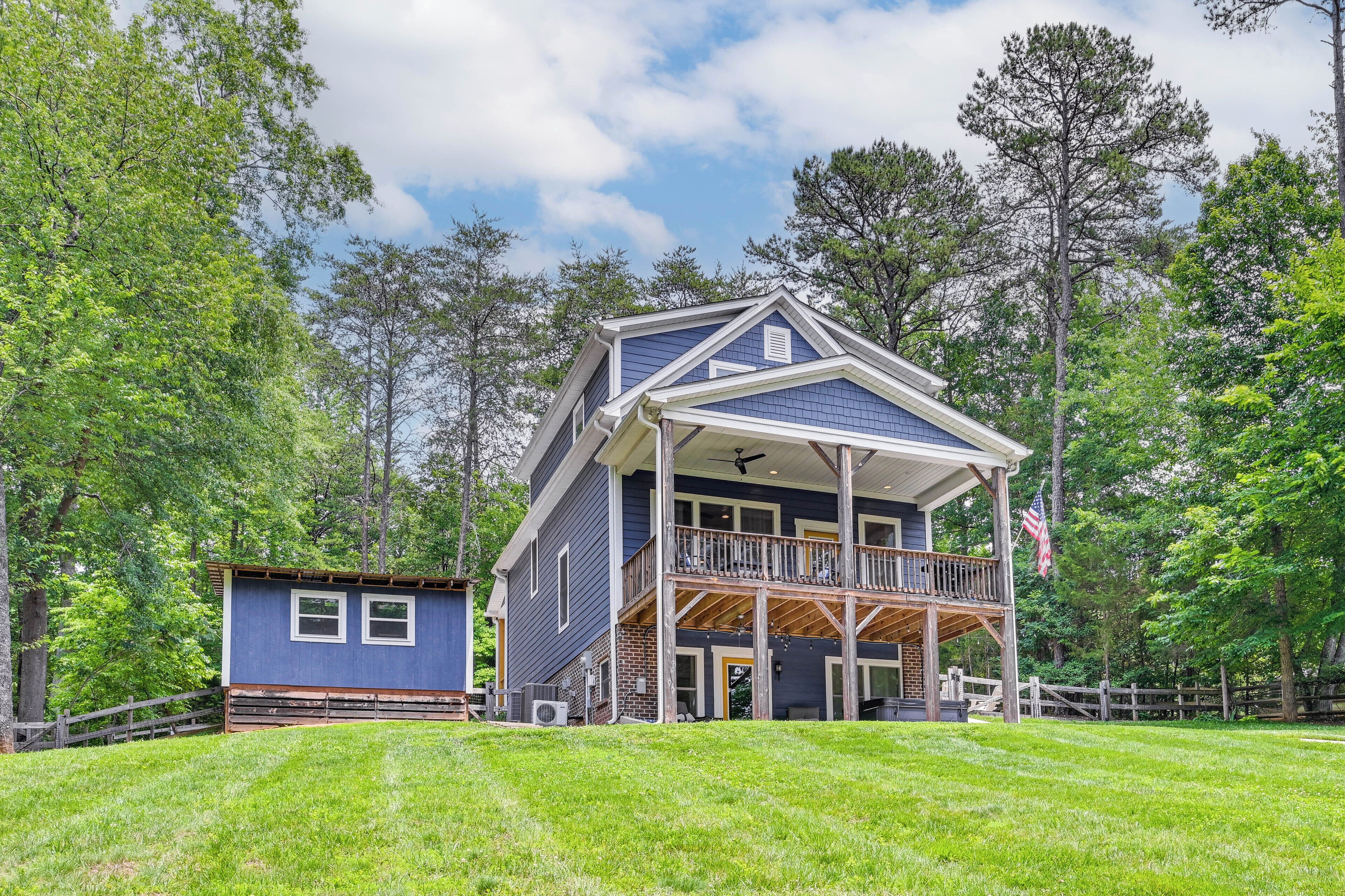 A two-story house with a balcony, a front porch, and a small attached garage.