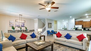 A spacious living room with two sofas, a coffee table, and a ceiling fan. - Game Room, Theater & More! Home 11 Mi to Disney (Davenport)